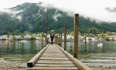 Girl walking down dock in New Zealand