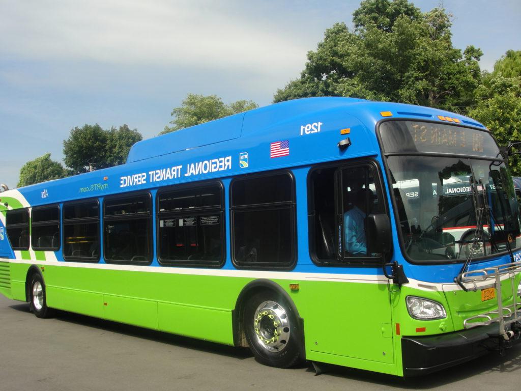 Blue and green RTS bus on city street